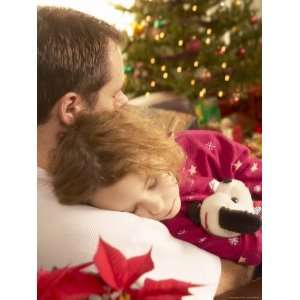  Father Holding Sleeping Daughter Beside Christmas Tree 