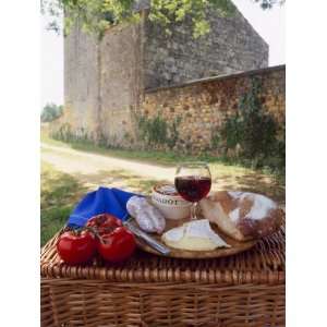  Picnic Lunch of Bread, Cheese, Tomatoes and Red Wine on a 